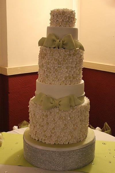 A 5 tier wedding cake (3 foot high) decorated with 800 sugar flowers and bows - Cake by Cakes o'Licious