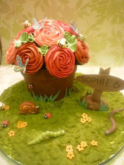 In the garden. Chocolate flower pot and cupcake roses. - Cake by The Faith, Hope and Charity Bakery
