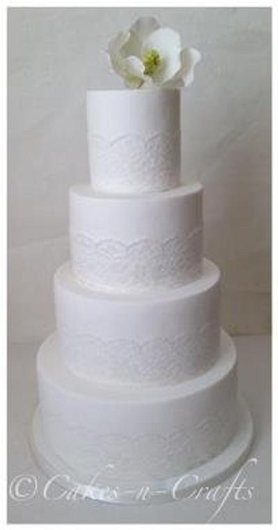 white 4 tier lace with sugar magnolia flower - Cake by June milne