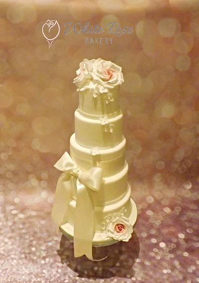 Elegant, simple roses, ribbon and tumbling hydrangeas wedding cake  - Cake by White Rose Bakery