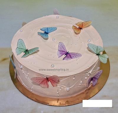 Colorful butterflies on peach cake - Cake by Sweet Mantra Homemade Customized Cakes Pune