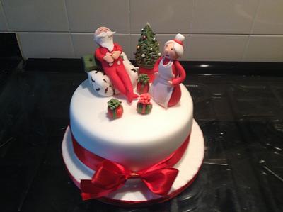 A little bit different. A sleeping Santa on a chair, with Mrs Claus not happy  - Cake by Tina Sweetman
