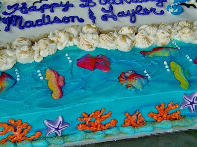 Beach cake in buttercream, sugar fish, and sanding sugar. - Cake by Nancys Fancys Cakes & Catering (Nancy Goolsby)