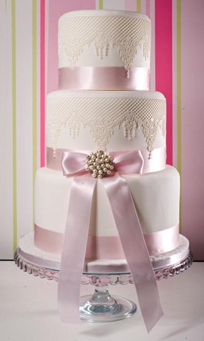 3 tier fondant iced stacked wedding cake with lace, ribbon and brooch detail - Cake by Bodissima Bespoke Wedding Cakes