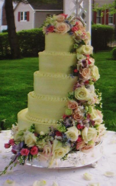 Buttercream wedding cake w/ cascading fresh flowers - Cake by Nancys Fancys Cakes & Catering (Nancy Goolsby)