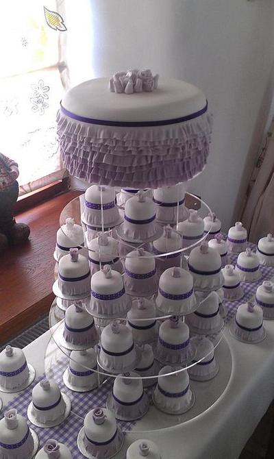 Rainbow cake with lilac Ombre frills and 70 - 2" matching mini cakes  - Cake by A House of Cake