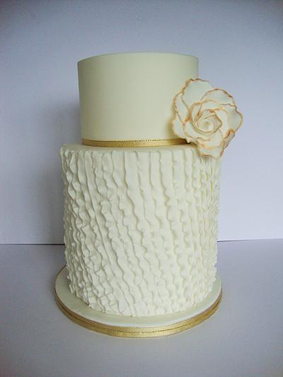 Diagonal ruffles with a large flower etched in gold. - Cake by Amy
