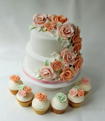 Pink and Peach wedding cake and 45 matching floral cupcakes. - Cake by Candy's Cupcakes