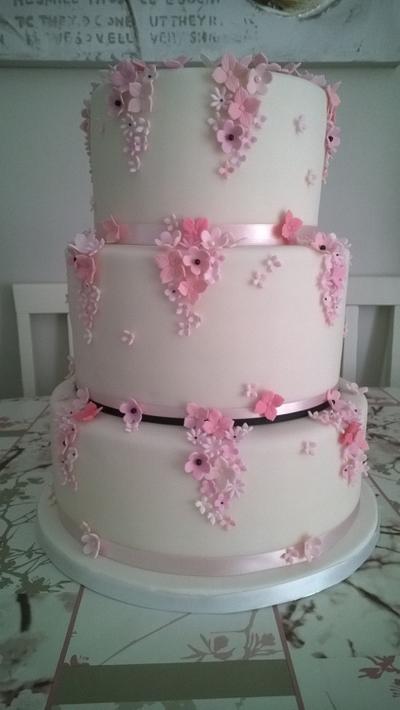 Wedding Cake with cascades of tiny pink flowers - Cake by Combe Cakes