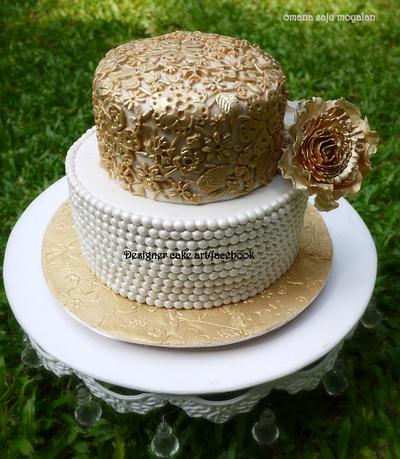 A simple vintage cake with gold lace work and sugar pearls . - Cake by omana saju