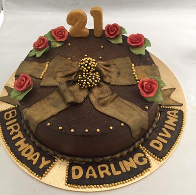 Chocolate mud cake with antique gold finish bow and edible roses !! - Cake by Manjari jain 