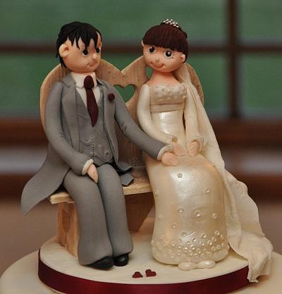 Bride and groom sitting on bench - Cake by Icing to Slicing