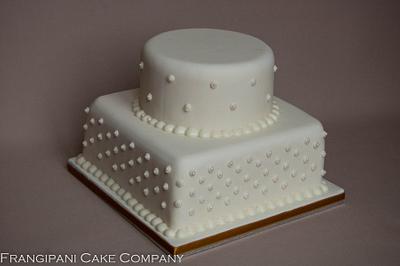 Two tiered ivory wedding cake with pearls - Cake by Frangipani Cake Company
