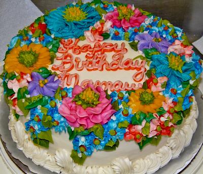 Buttercream cake with aray of flowers - Cake by Nancys Fancys Cakes & Catering (Nancy Goolsby)