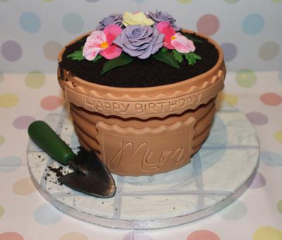 A Terracotta Flower Pot Cake with handmade Roses and Pansies completed with a handmade trowel  - Cake by Cake Creations By Hannah