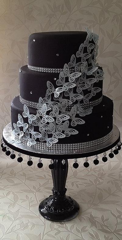 black and silver butterfly cake on homemade cake stand - Cake by The lemon tree bakery 