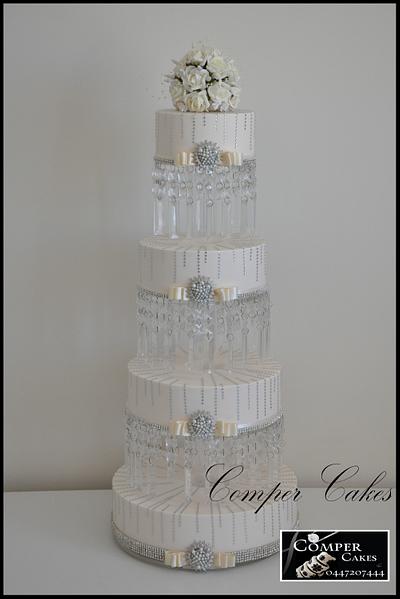 Tall wedding cake on crystal stand. - Cake by Comper Cakes