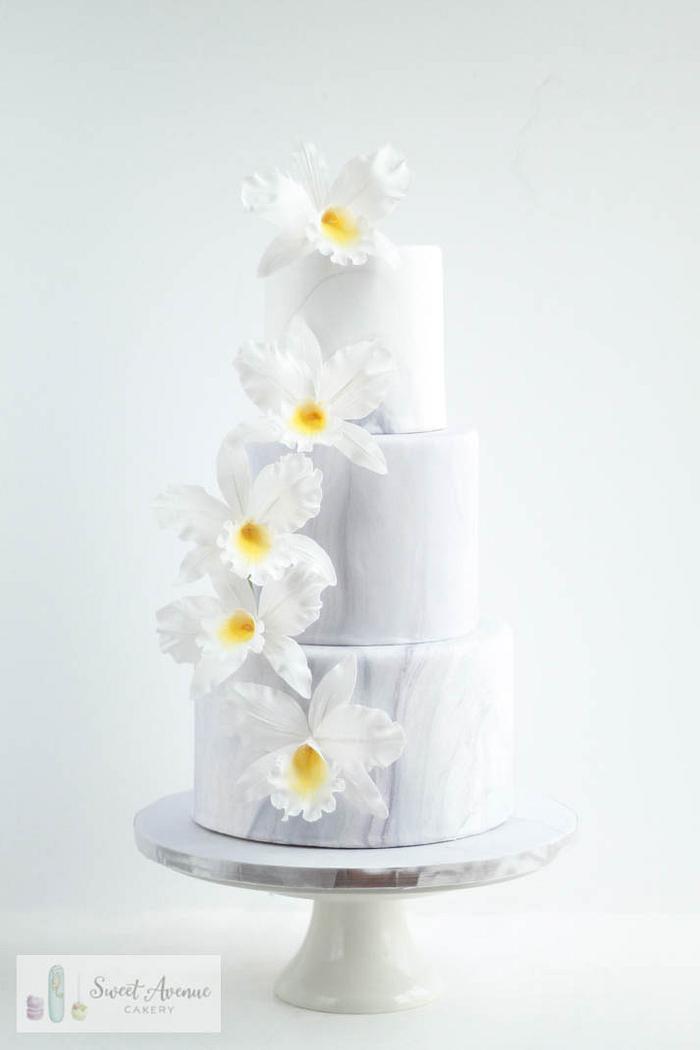 Marble wedding cake with orchids cascade
