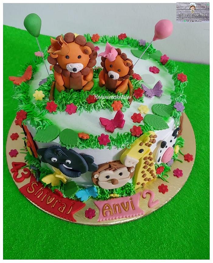 A Cute Jungle theme cake with Simba and animals on it