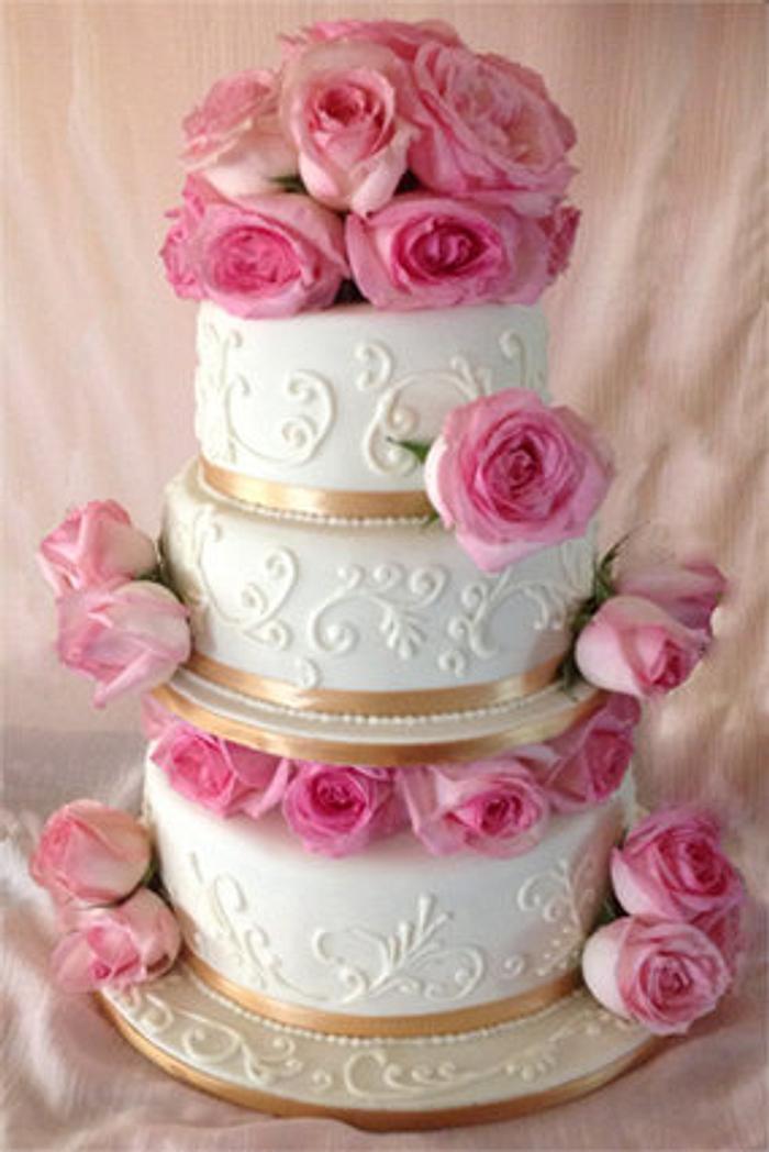 Ivory wedding cake with blush pink roses