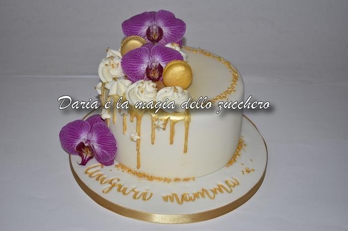 Gold drip cake with orchids