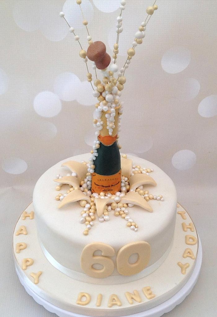 Popping champagne corks 60th birthday cake