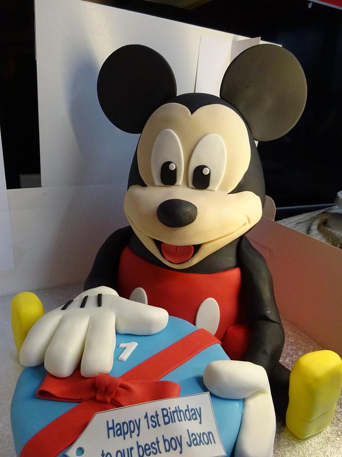 Mickey Mouse sitting with his present.