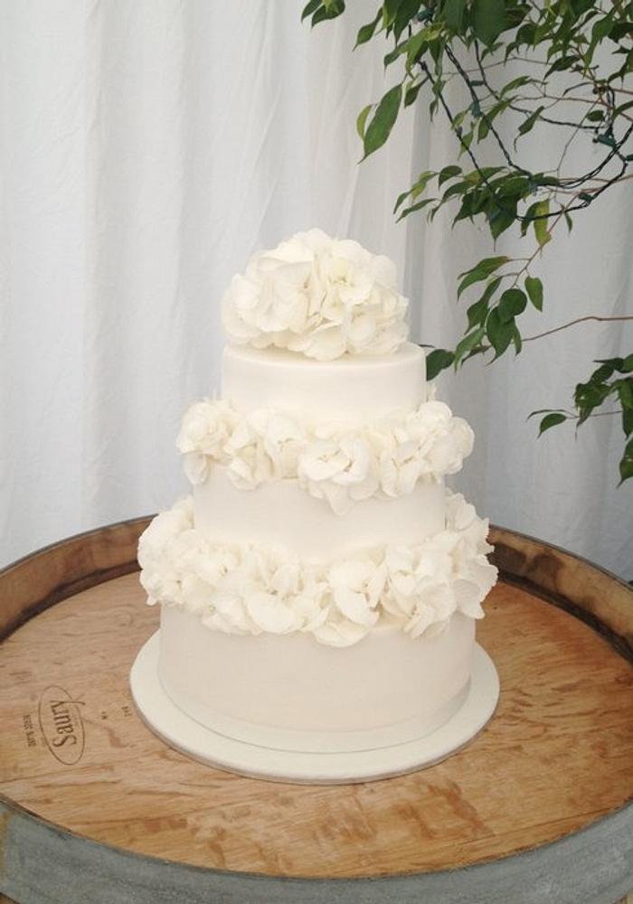 All white wedding Cake with fresh flowers