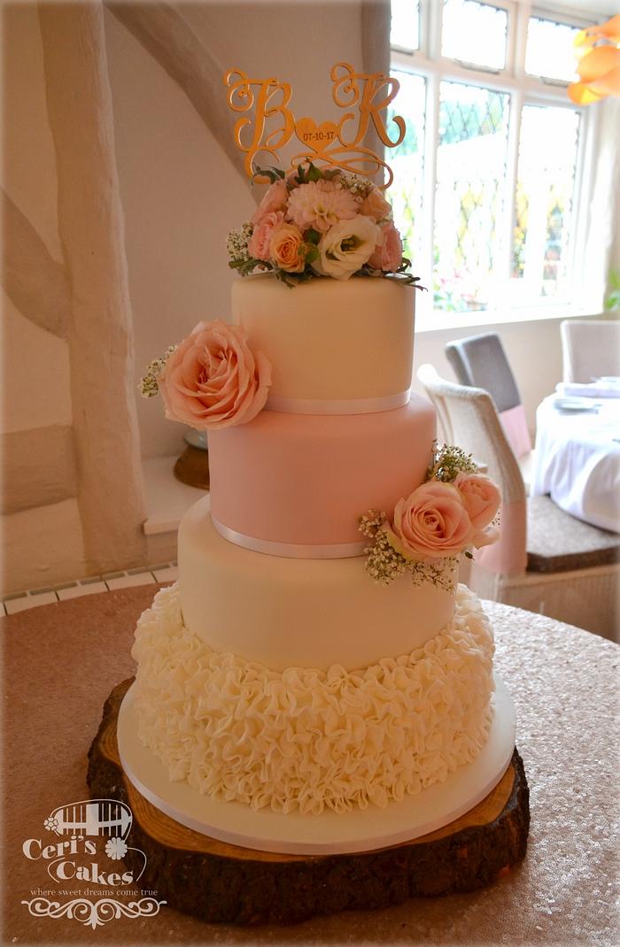 Blush pink roses and white ruffles wedding cake