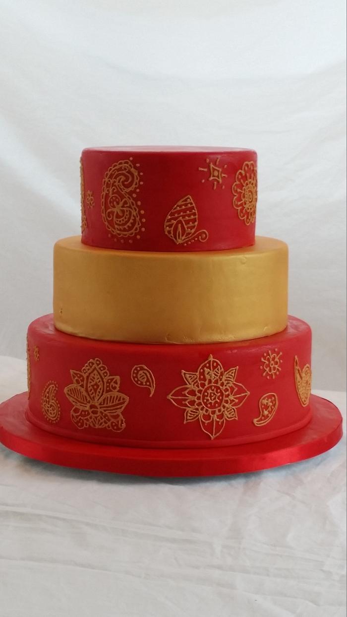 Red and gold mehndi wedding cake
