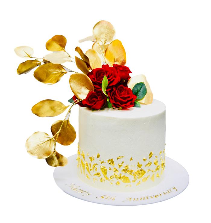 White and gold cake with red roses