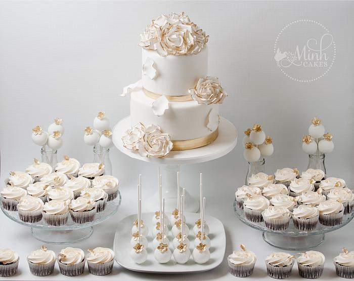 Sweet wedding dessert table in gold and white