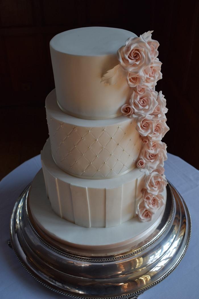 Elegant wedding cake with cascading roses