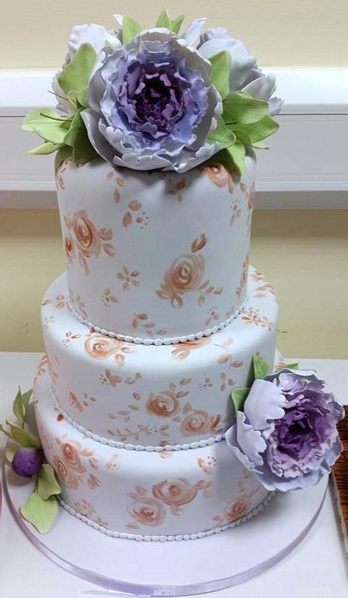 Lilac and rose gold wedding cake with peonies
