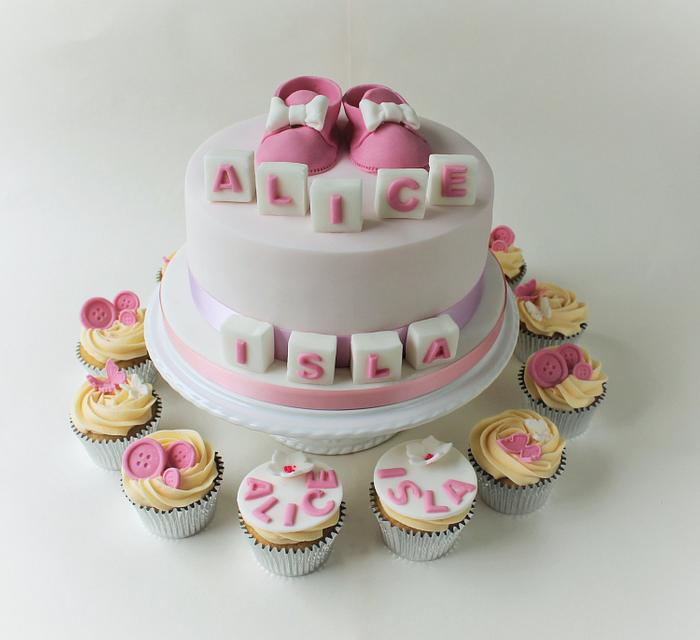 Christening cake with booties and matching cupcakes