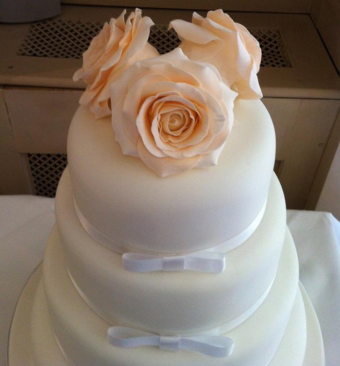 Four Tier Ivory Bow wedding cake with Peach Roses