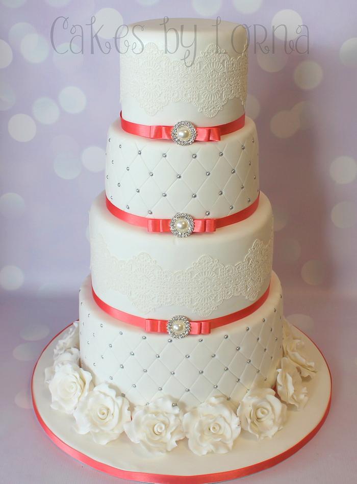 Four tier white and coral wedding cake