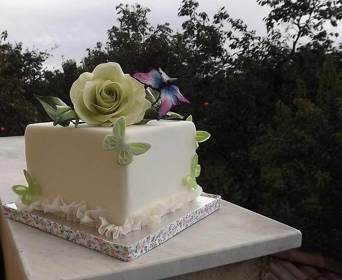 square cake with flower and butterfly