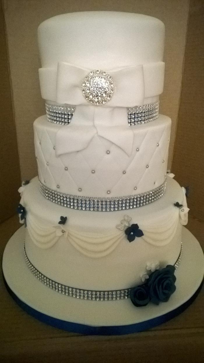 White wedding cake with bling and some Royal Blue touches