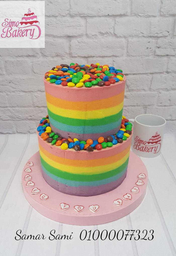 Colorful striped buttercream and m&m's cake 