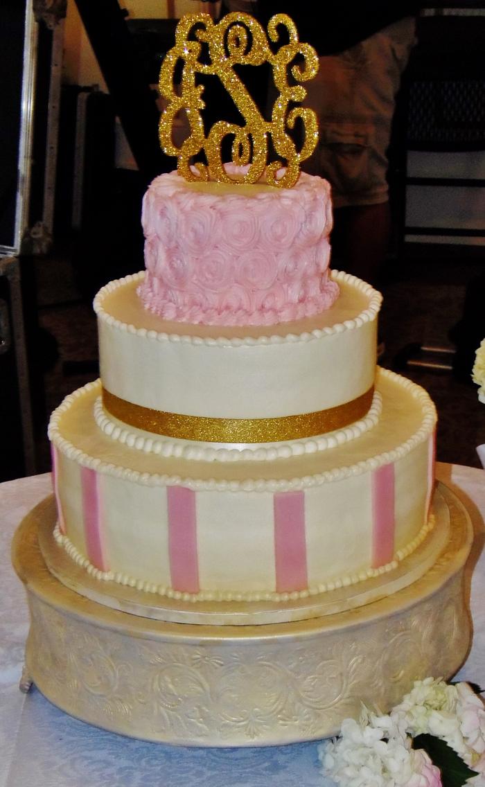 Pink rosette and stripe wedding cake