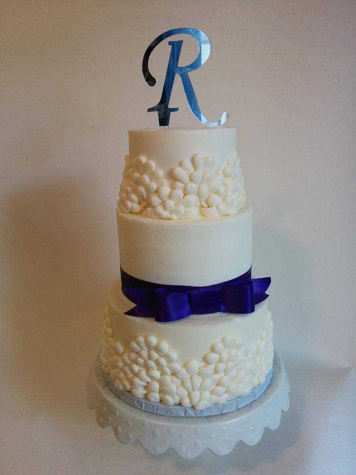 simple buttercream with purple ribbon