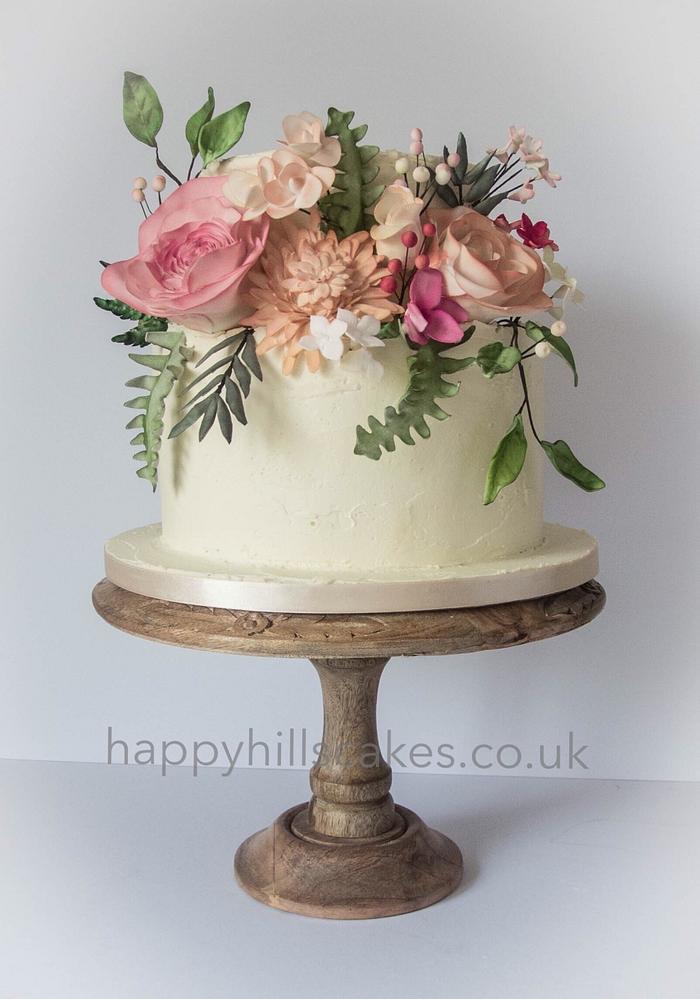 Corals, pinks and foliage natural wedding cake 