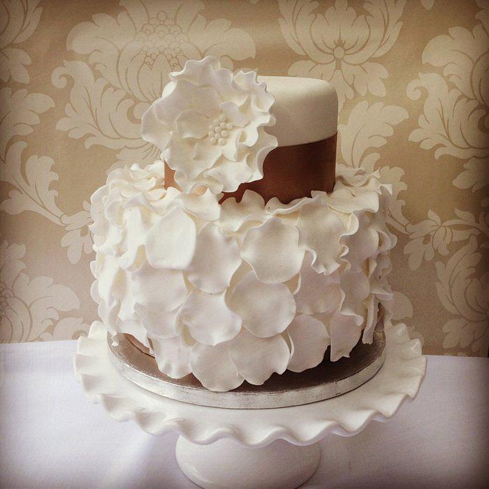 White 2 tier cake with sugar petal accents