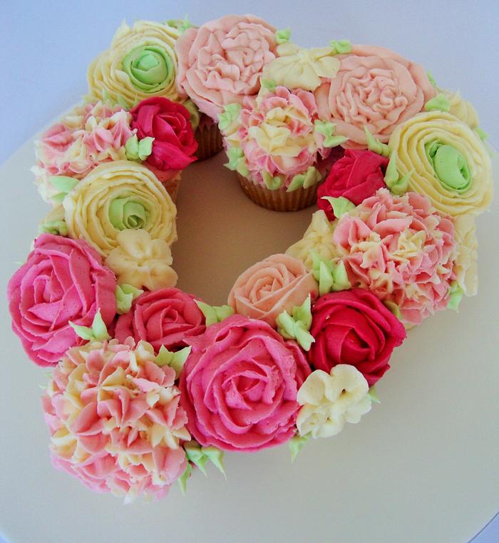 Floral heart cupcake display.
