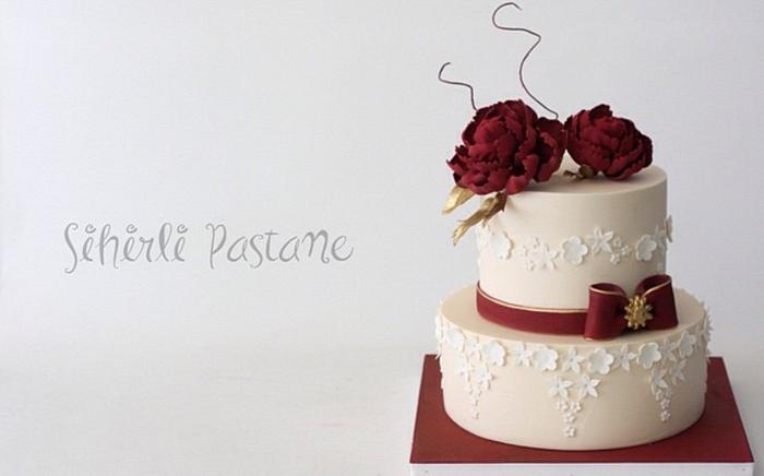 Minimalist four tier wedding cake with burgundy silk ribbon