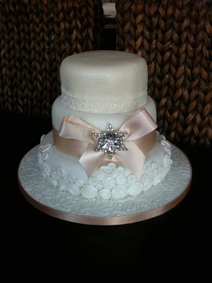 Buttons bows and lace wedding cake 
