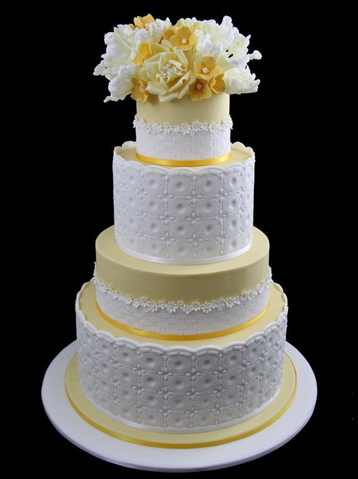 yellow wedding cake with tulips, roses and hydrangea