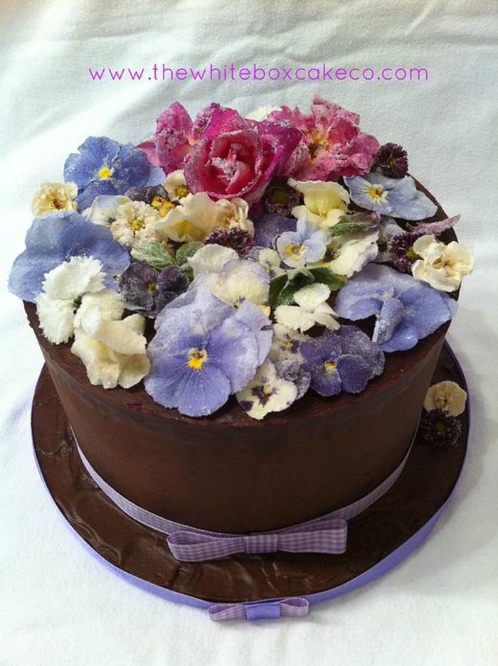 crystalized flowers on ganached cake