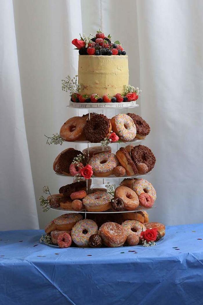 Naked cake fresh fruit and donuts.